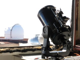 Kopule dalekohledu Keck je vidět přes otevřenou štěrbinu kopule CFHT